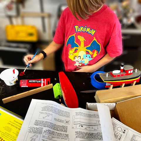 Kid constructing a Scorpion Boat